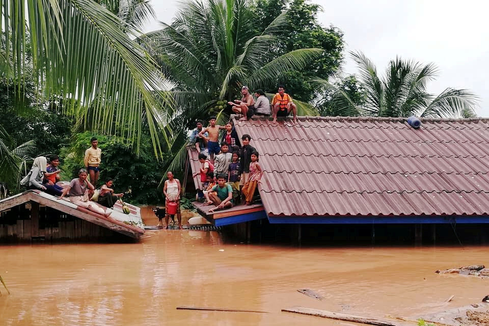 People took shelter on rooftops in Attapeu Province in southern Laos, a day after a hydropower dam’s failure flooded villages and farmland. The prime minister said Wednesday that 131 people were still missing.Credit: Reuters