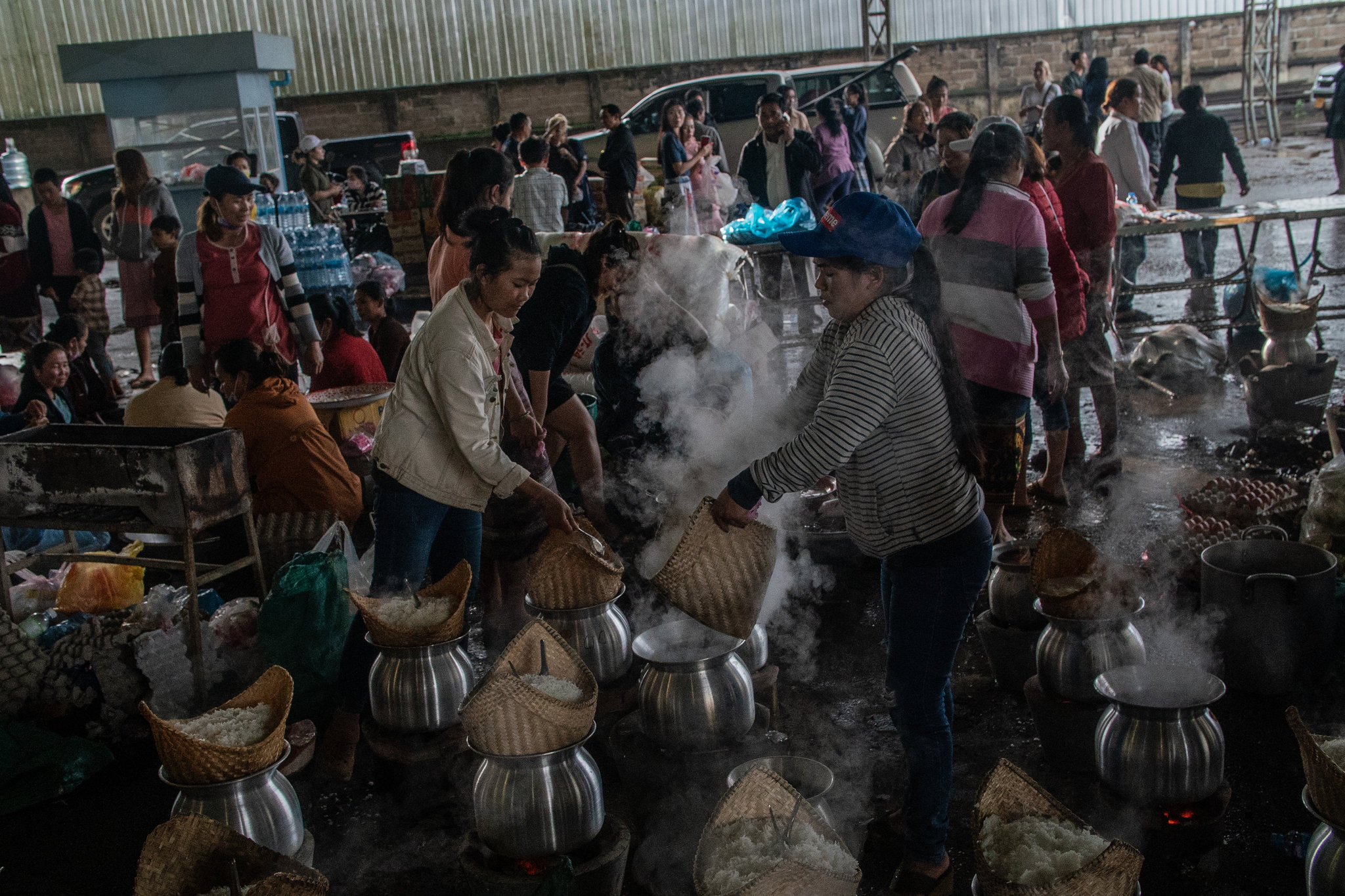 Volunteers preparing rice for people displaced by the dam collapse.CreditBen C. Solomon/The New York Times