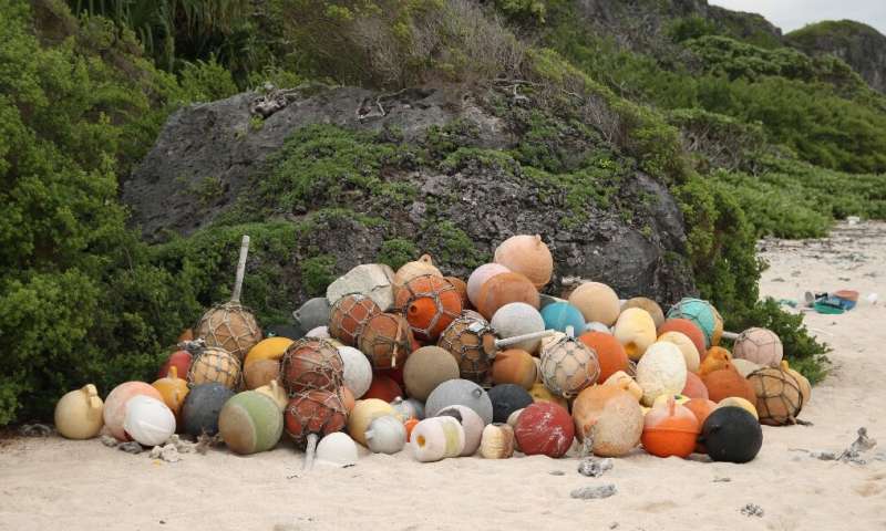 A pile of collected fishing bouys on a beach on Henderson Island, an uninhabited part of the Pitcairn archipelago in the South Pacific Ocean