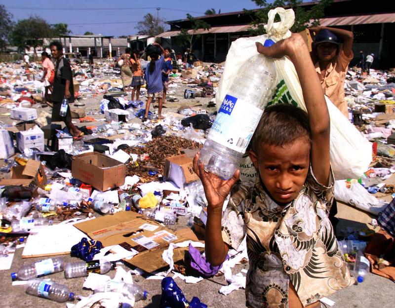 FILE PHOTO - East Timorese collect plastic containers and leftovers at a garbage dump in Dili September 27.