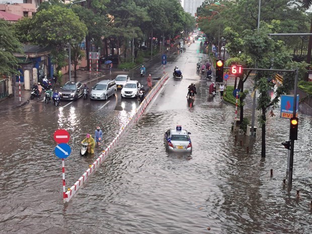 A street in Hanoi is flooded after heavy rains. (Photo: VNA)